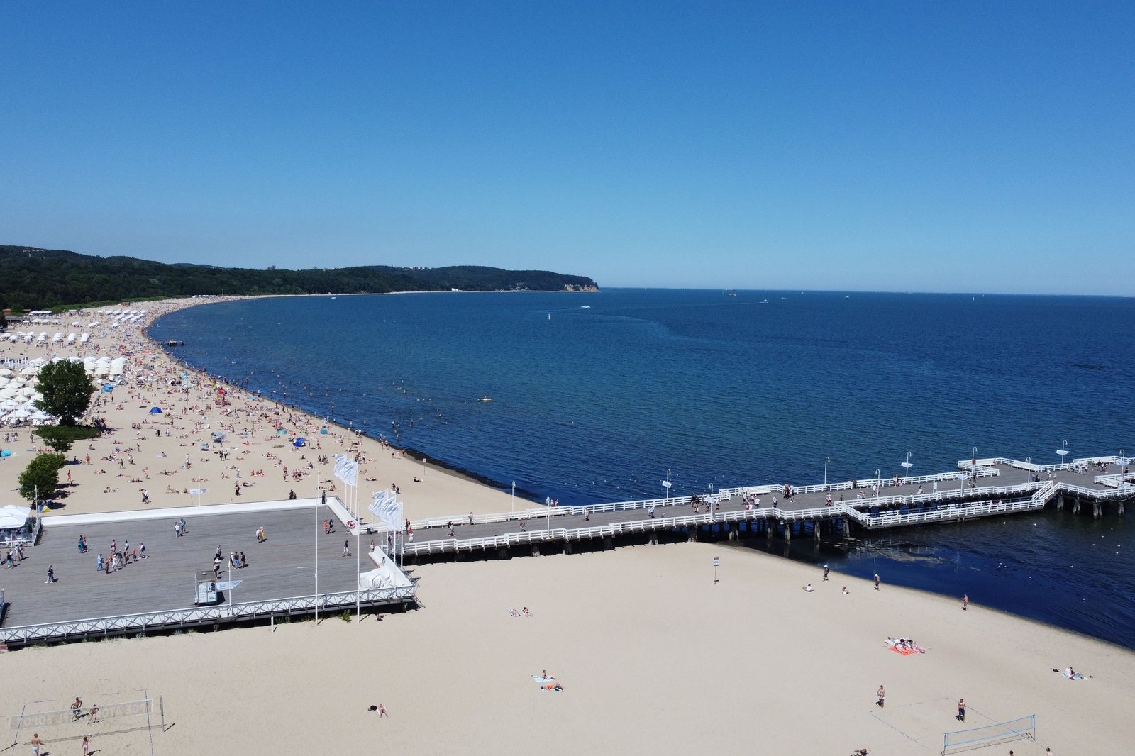 Sopot from above, a long white beach curving along the Baltic and the wooden pier running out into blue water