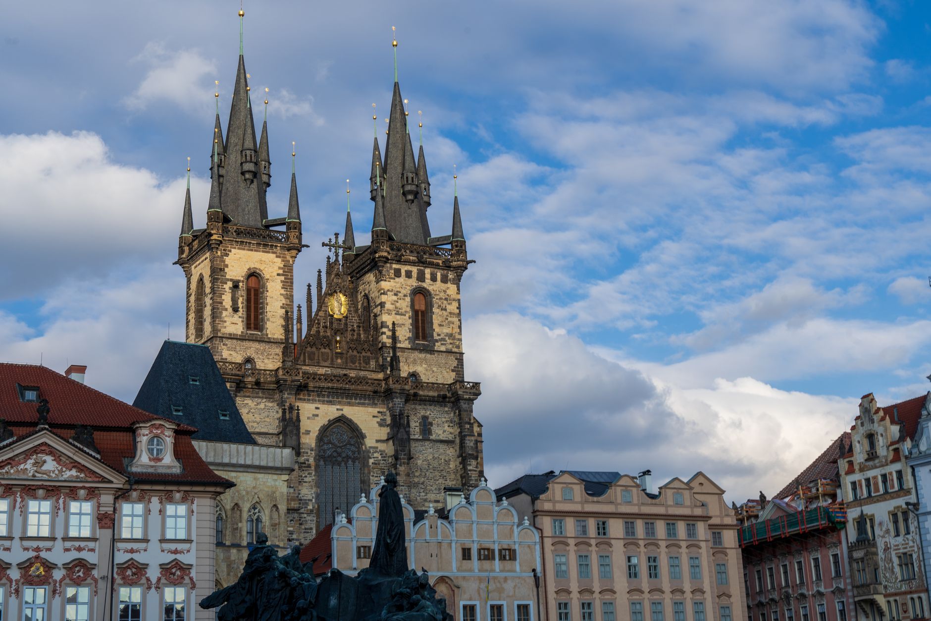 The twin gothic spires of the Church of Our Lady before Týn rising over Old Town Square