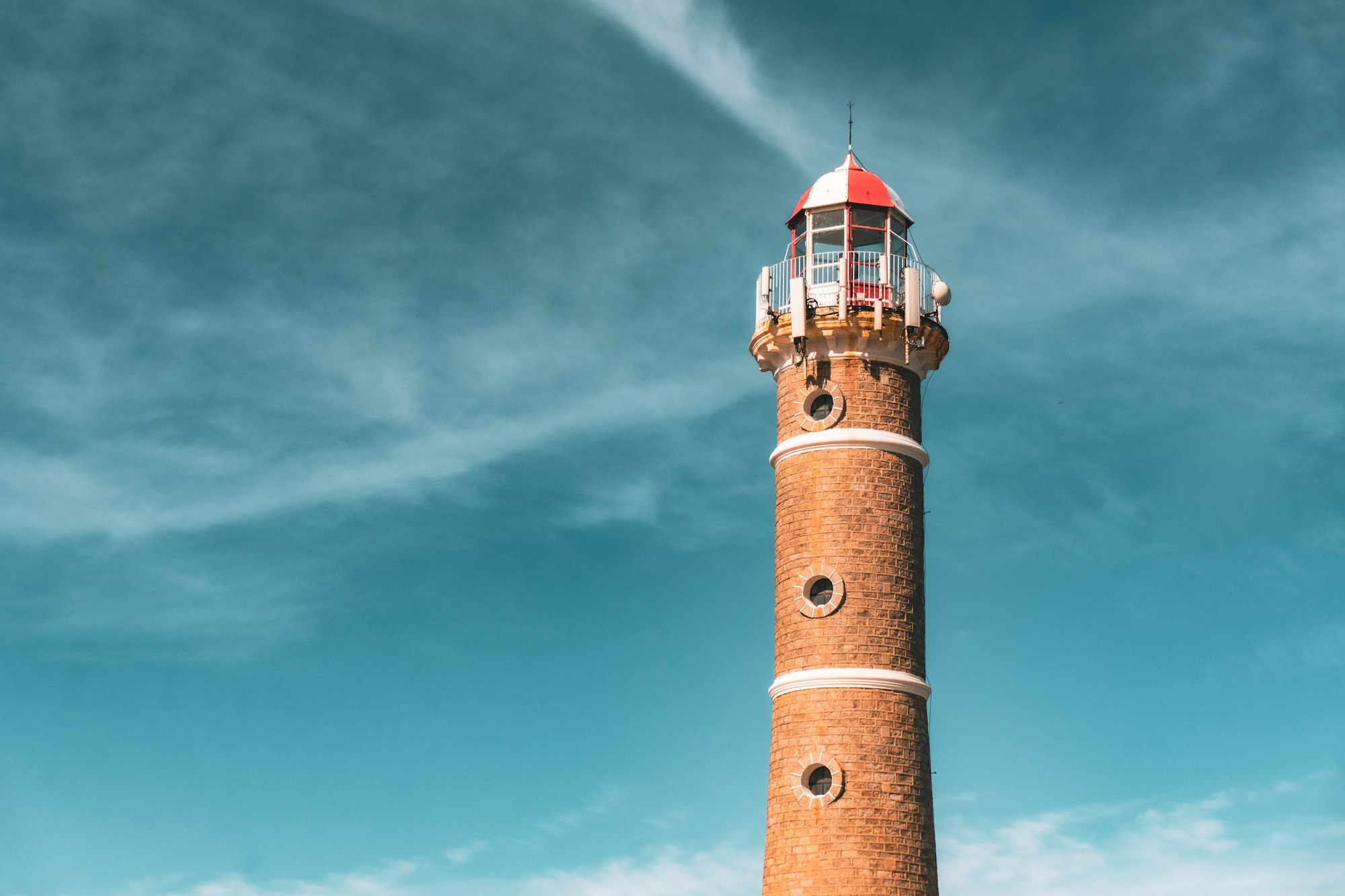 The black and white lighthouse at Jose Ignacio above a wide beach