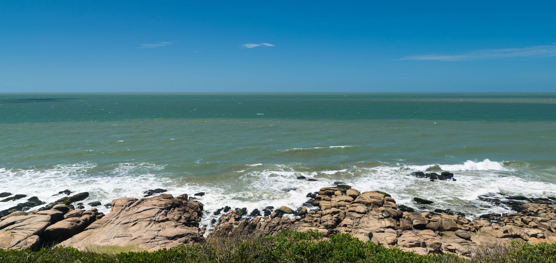 A cliff-backed surf beach at La Pedrera