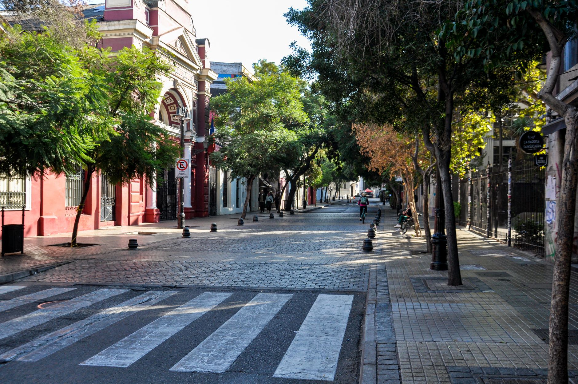 A tree-lined street of low painted houses in Barrio Bellavista