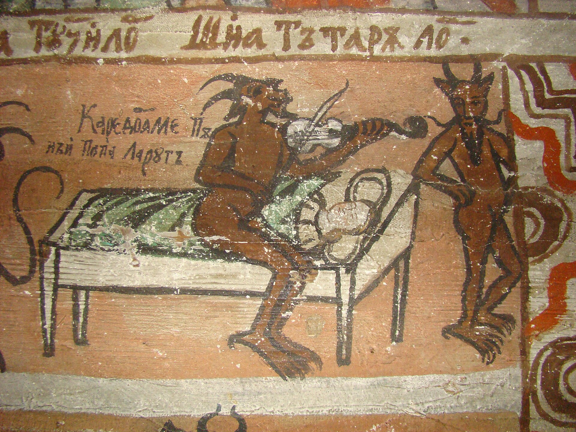 A painted church wall showing a horned devil playing a fiddle beside a figure lying on a bed