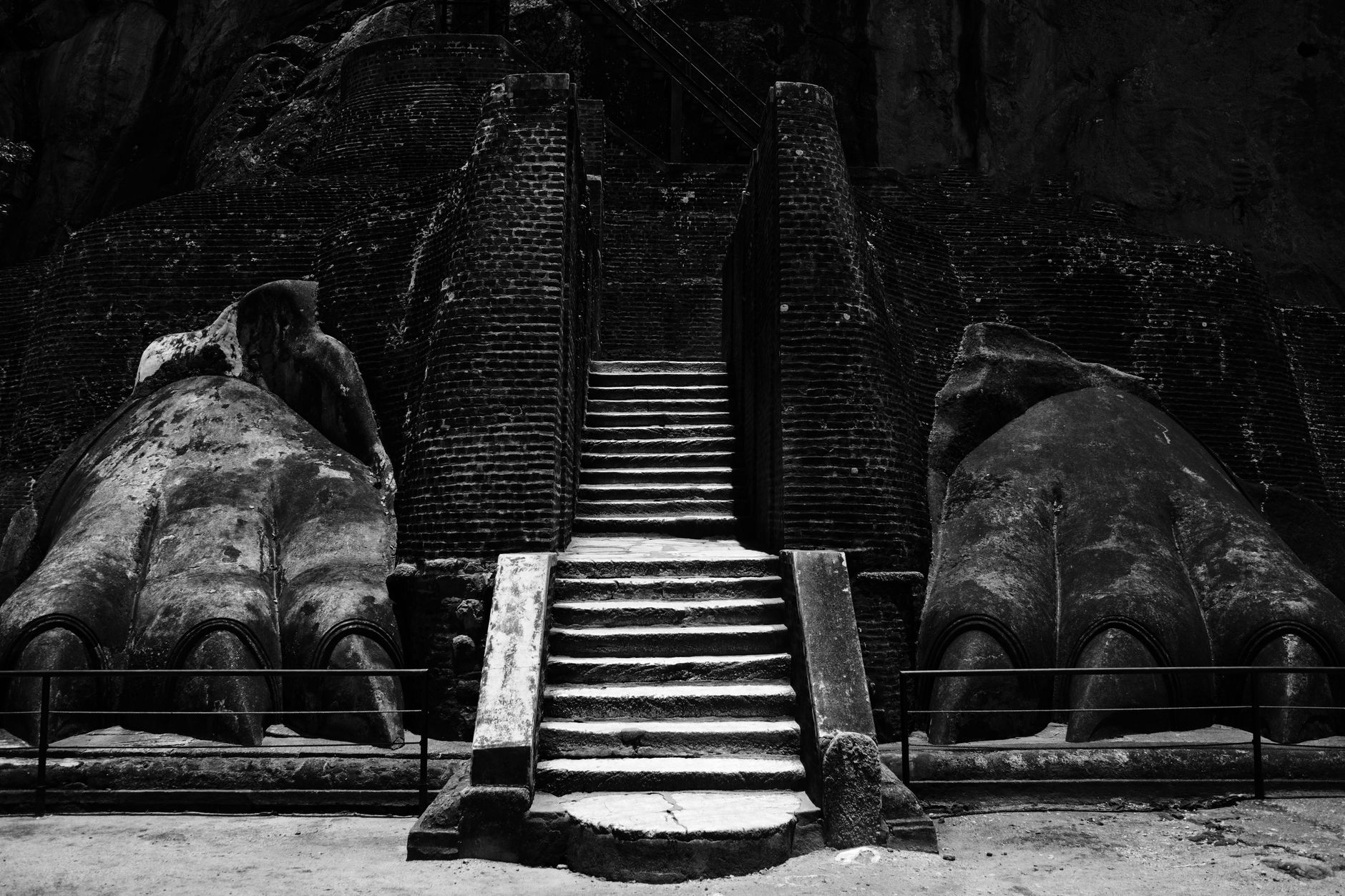 The two giant carved stone lion paws flanking the final staircase at Sigiriya