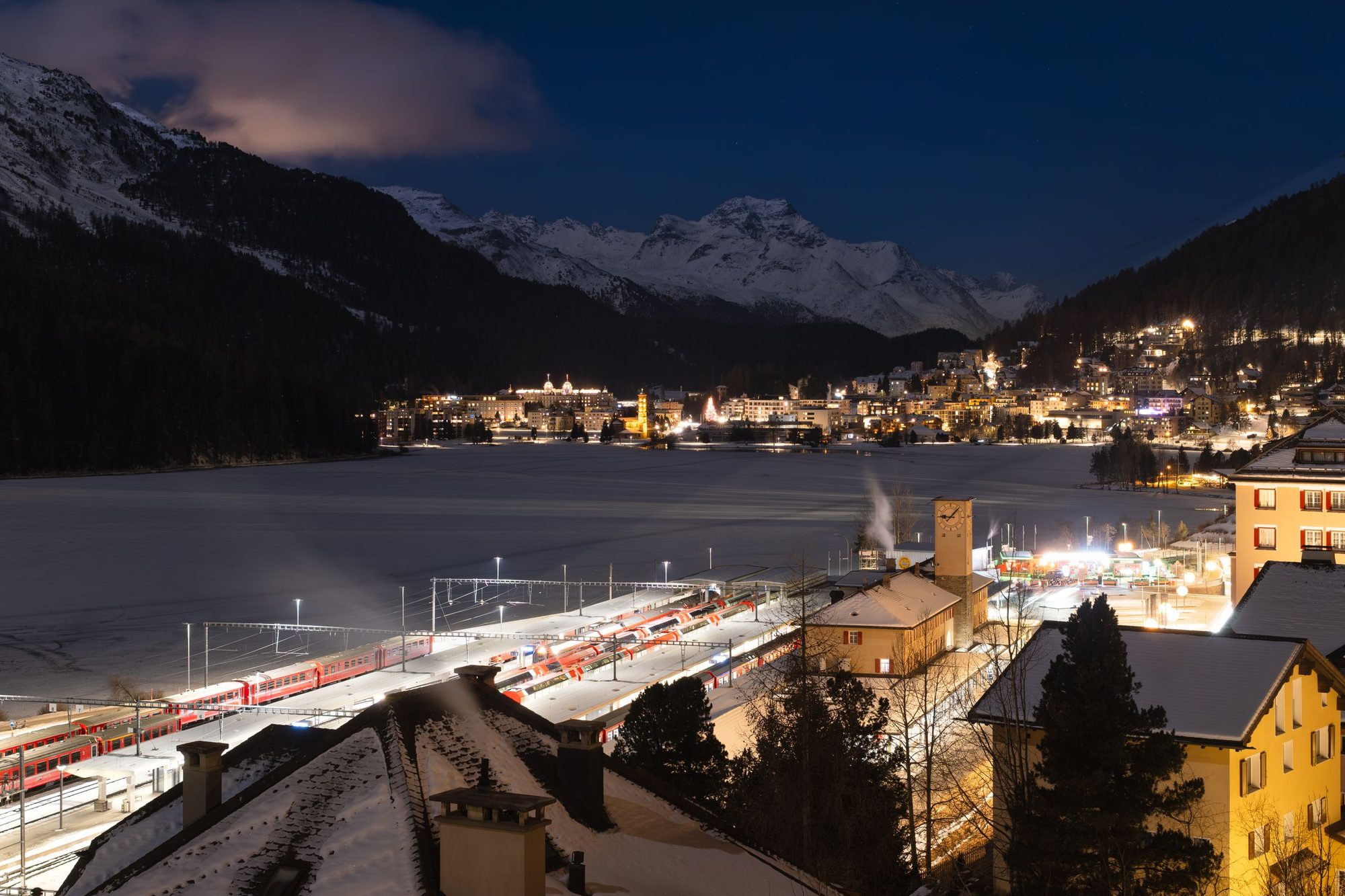 St. Moritz at night above the frozen lake, the railway station lit below