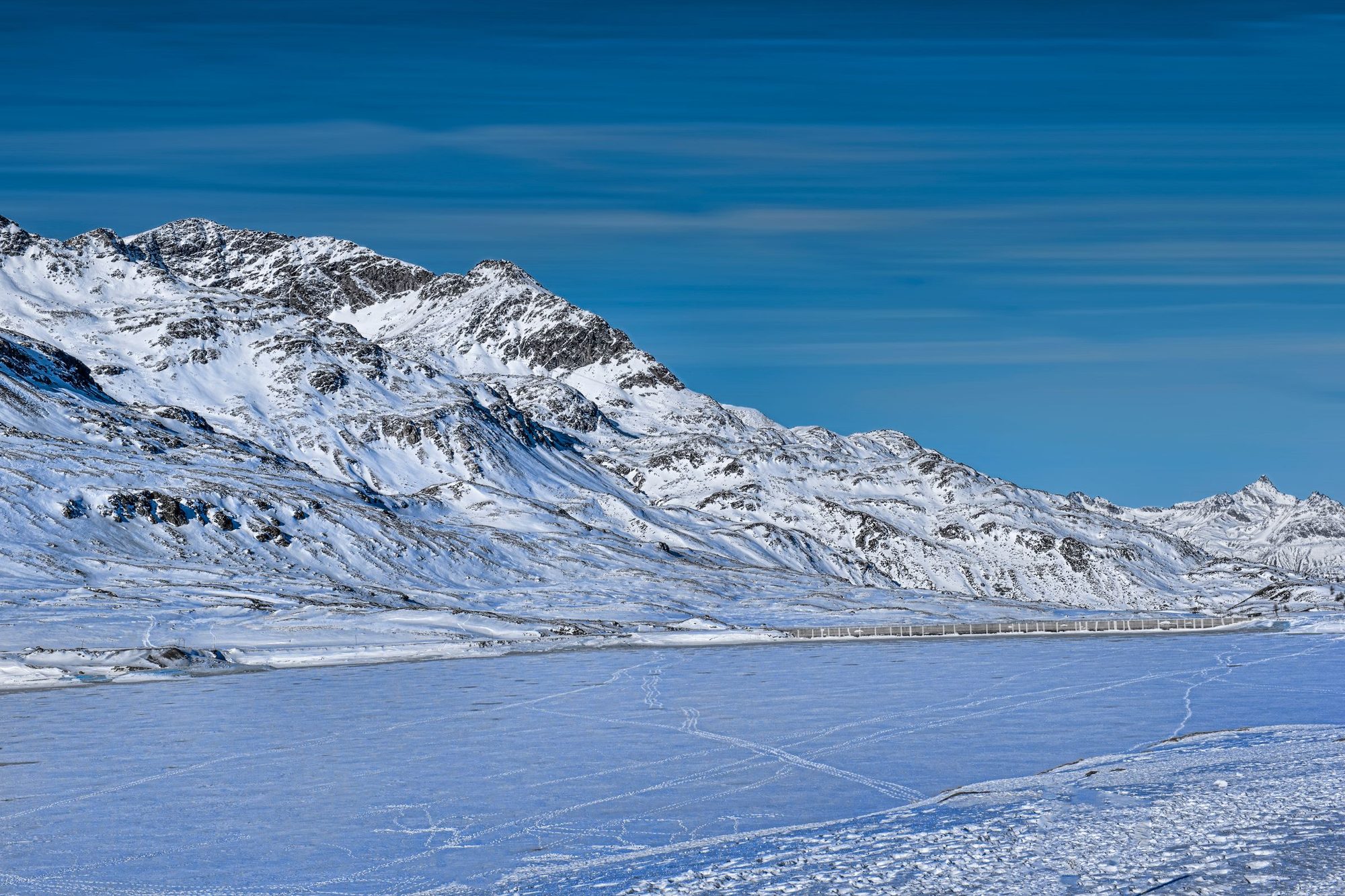 Snow-covered peaks above a frozen Engadine valley at St. Moritz