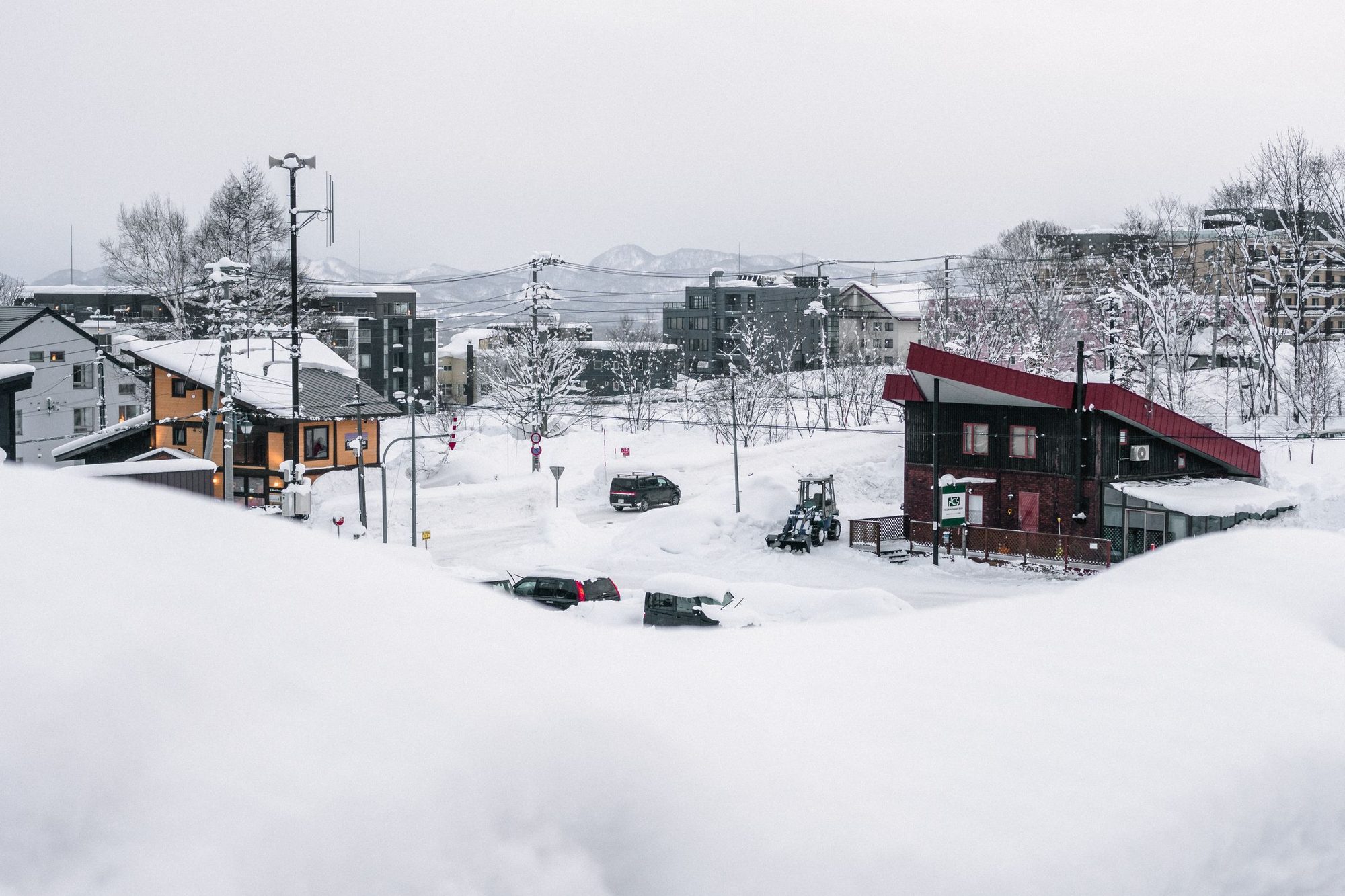 Chalets and lodges under deep snow in the village below the lifts, Niseko