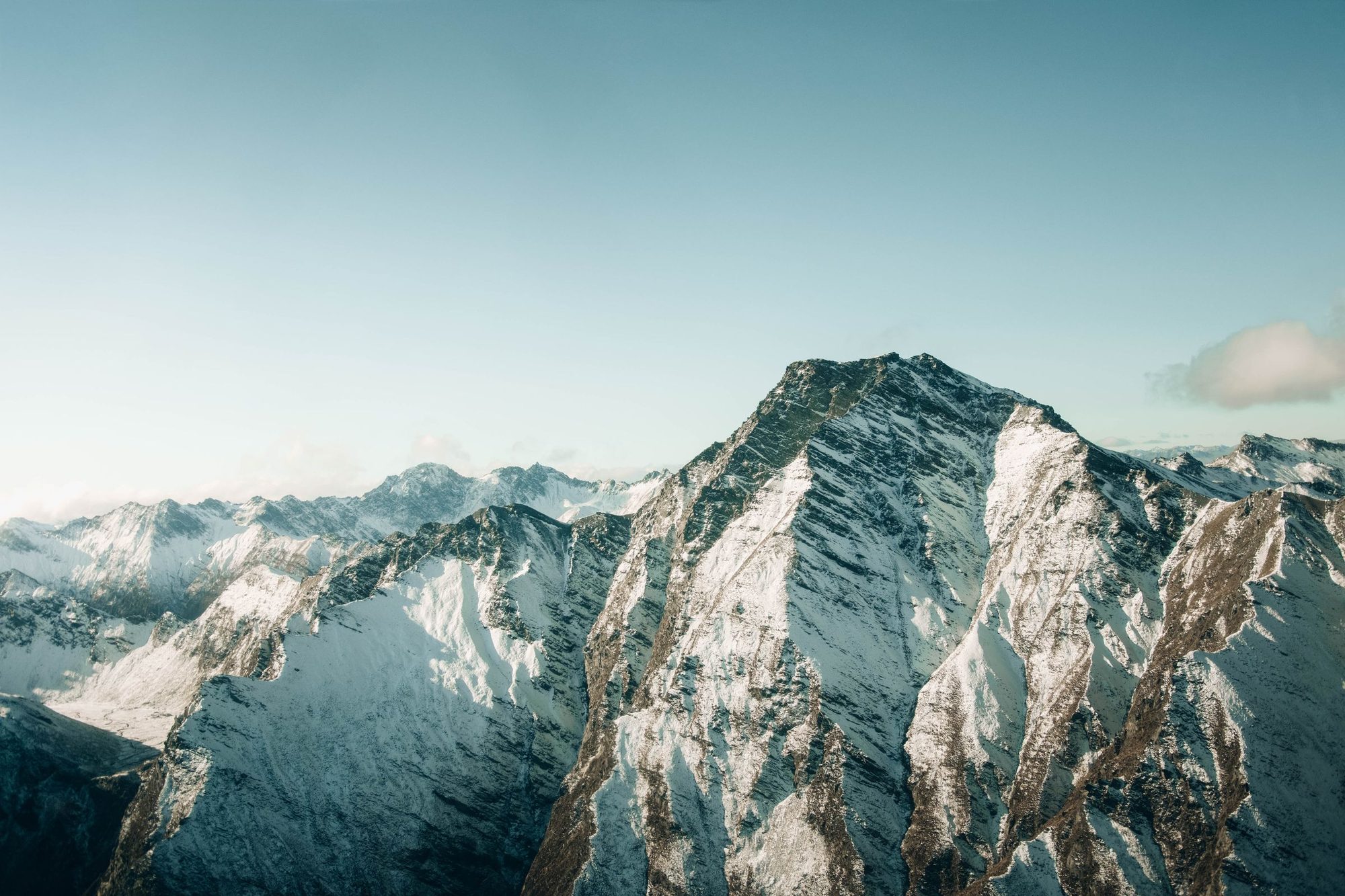 Snow-covered peaks and ridges above Queenstown in winter, seen from the air