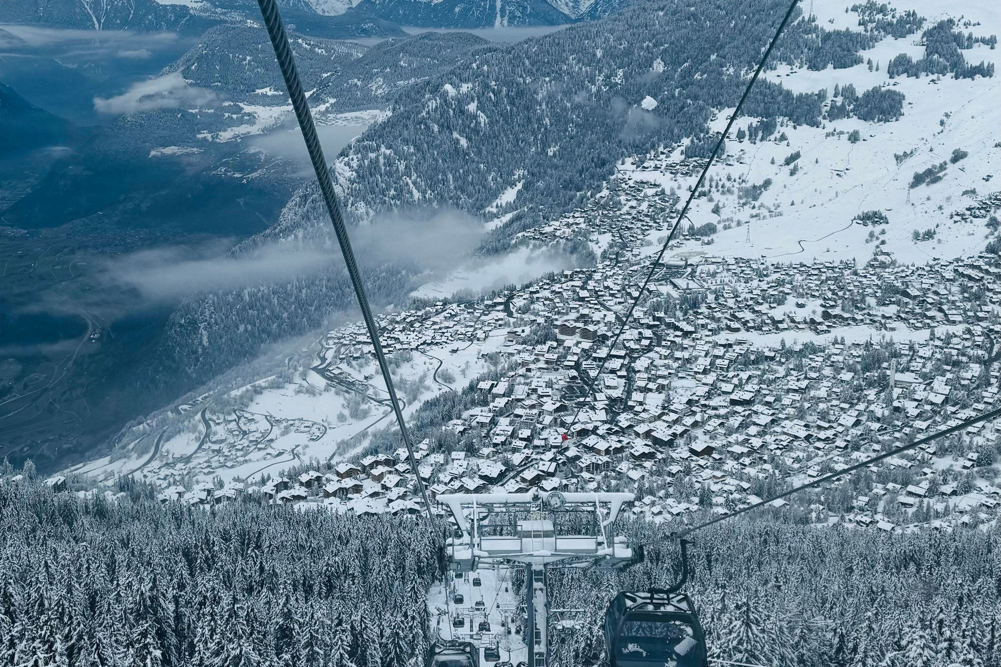 Verbier's chalets under snow, seen from the gondola climbing from Le Châble