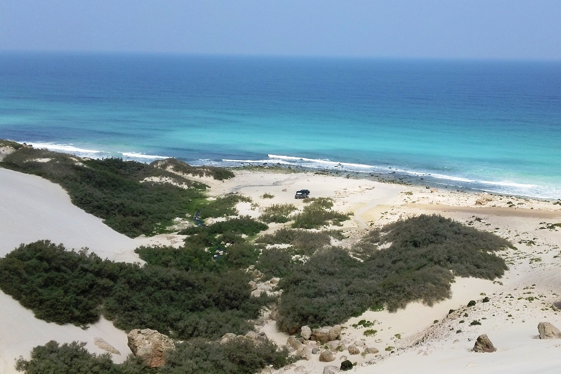 White dunes and scrub running down to the sea at Arher on the north coast of Socotra
