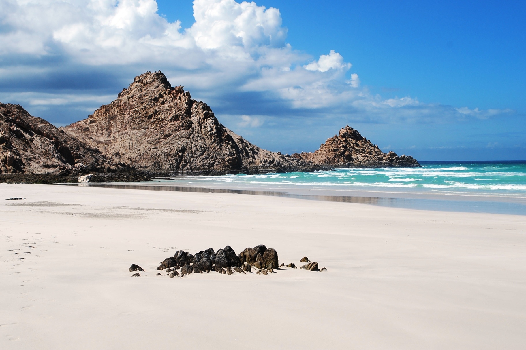 Empty white sand and rocky headlands above turquoise water at Detwah, near Qalansiyah on Socotra