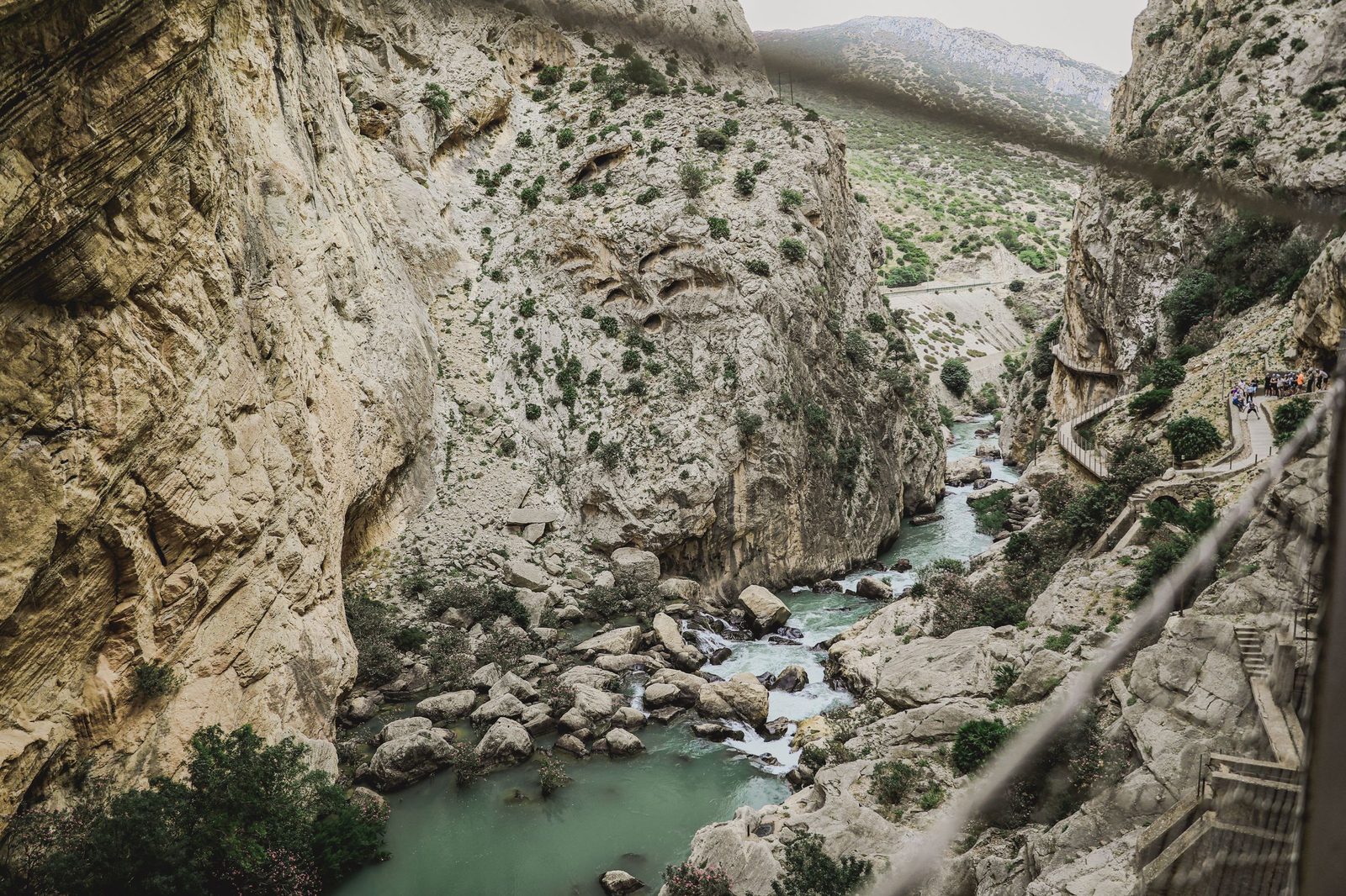 The gorge of the Caminito del Rey near Málaga, pale limestone walls above a green river and a walkway fixed to the rock