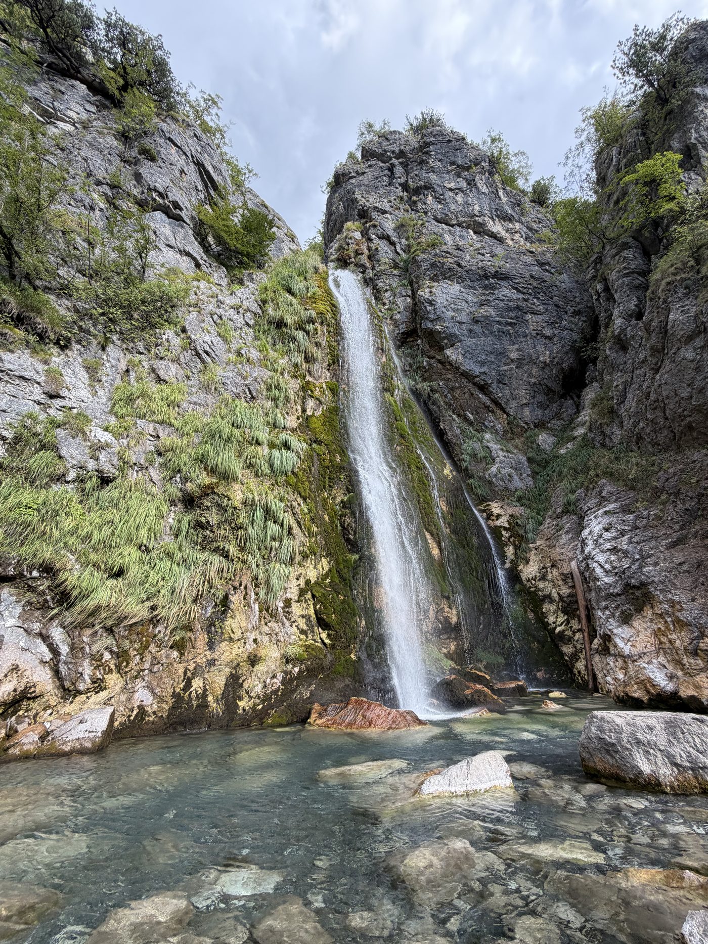 Grunas Waterfall falling into its rock basin