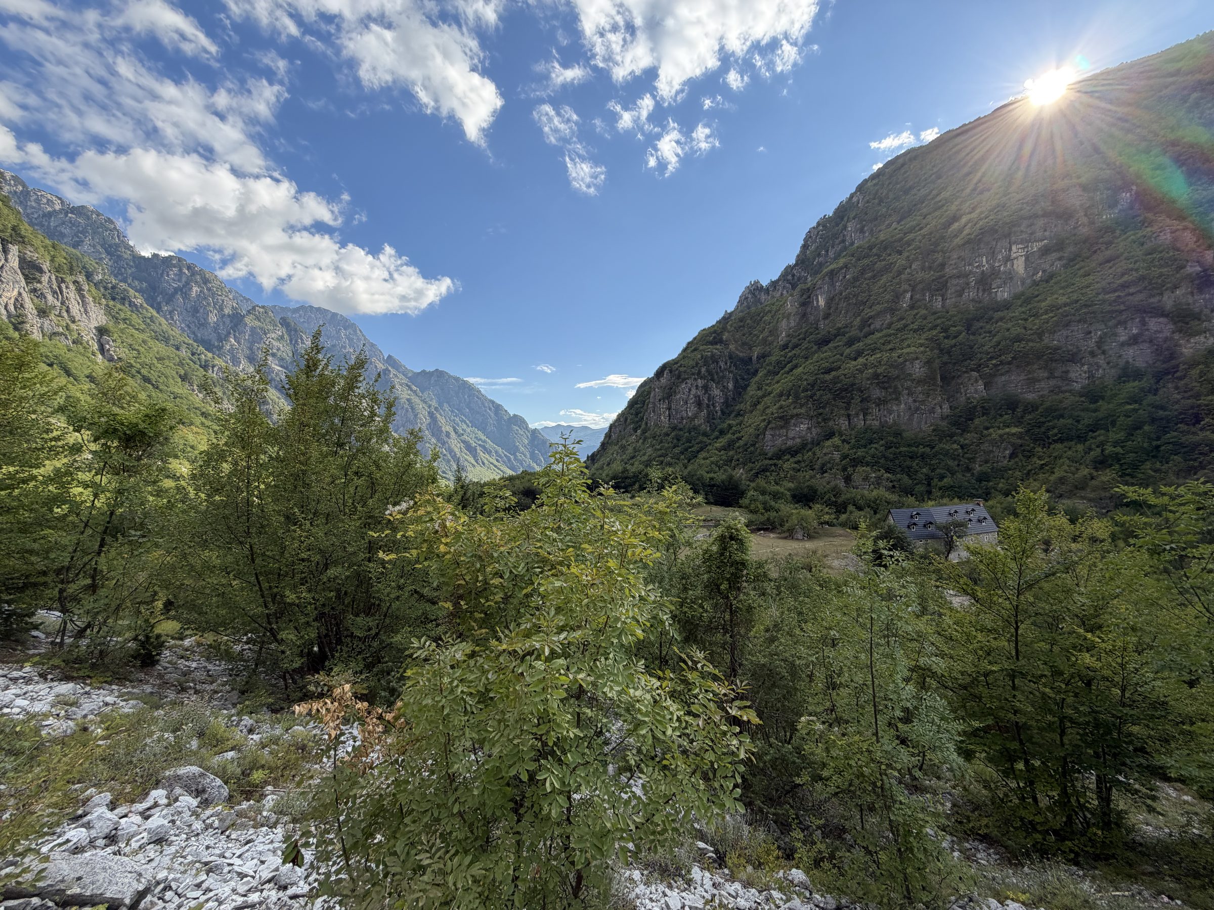 The Grunas trail above the river, with the Theth valley and its peaks behind