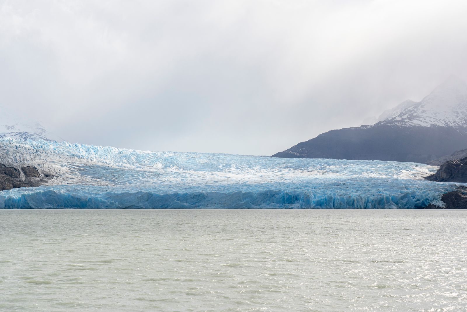 The front of Grey Glacier across Lago Grey under low cloud
