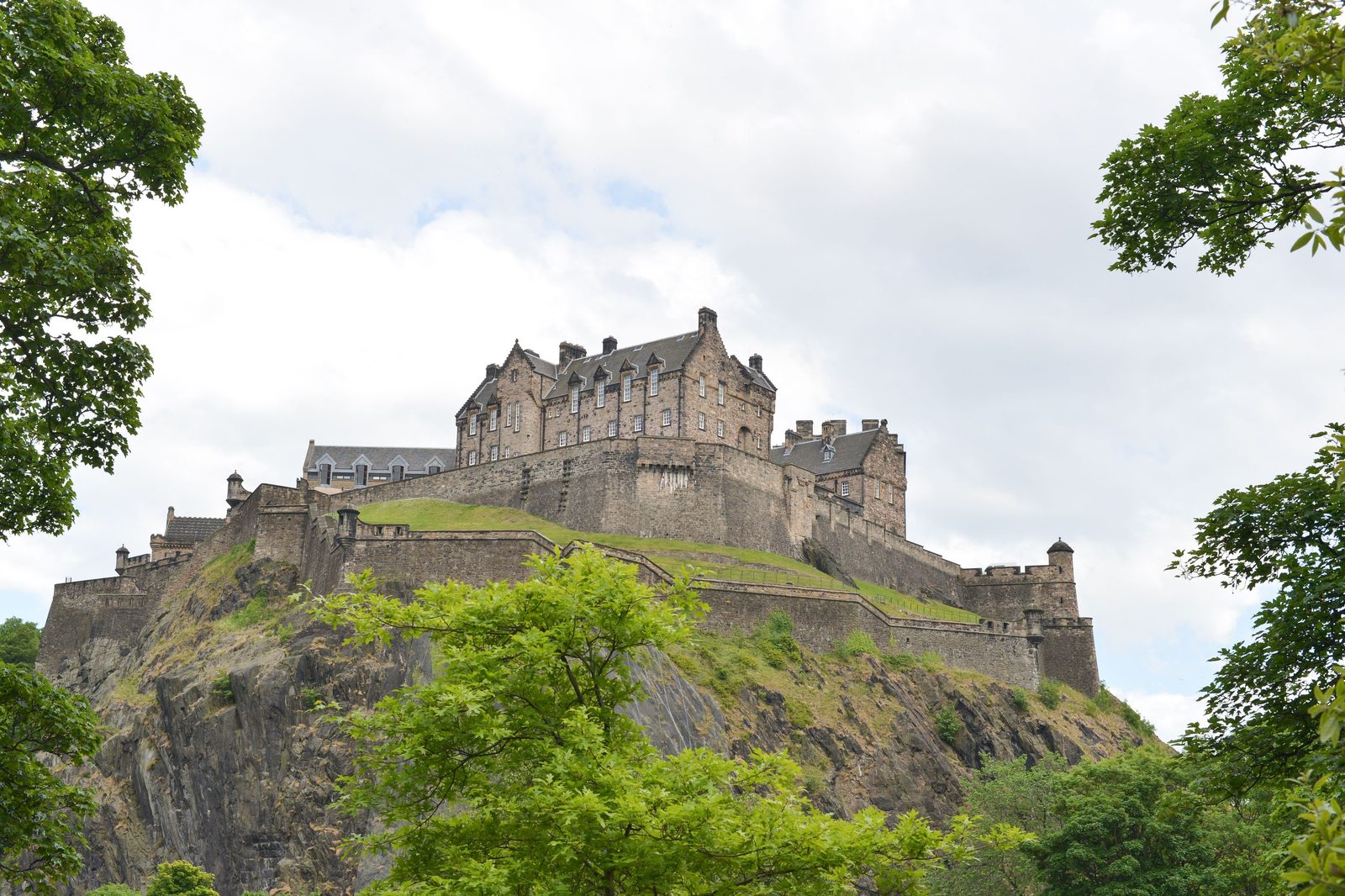 Edinburgh Castle on Castle Rock framed by trees