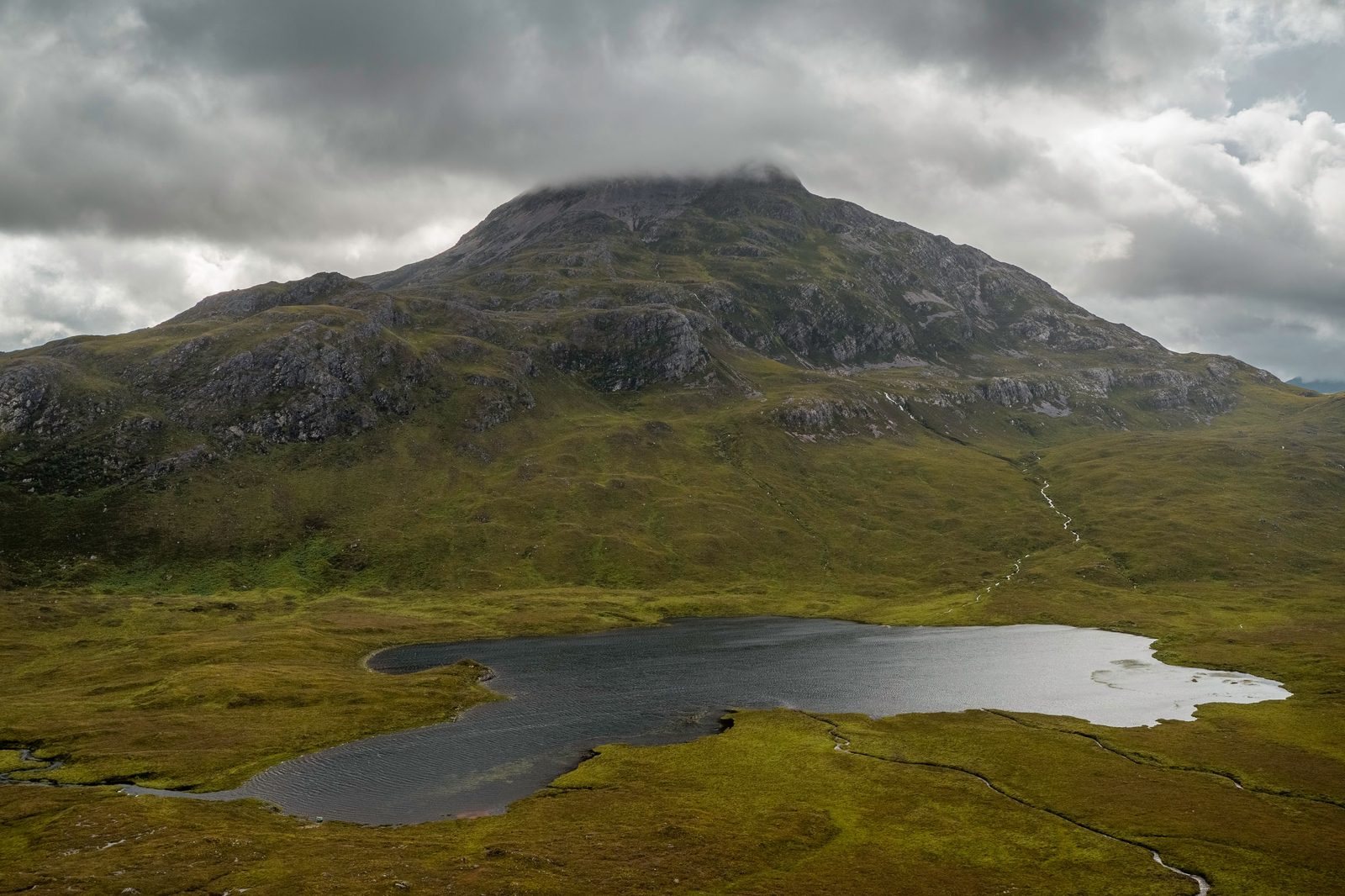 Torridon mountains above a lochan under cloud
