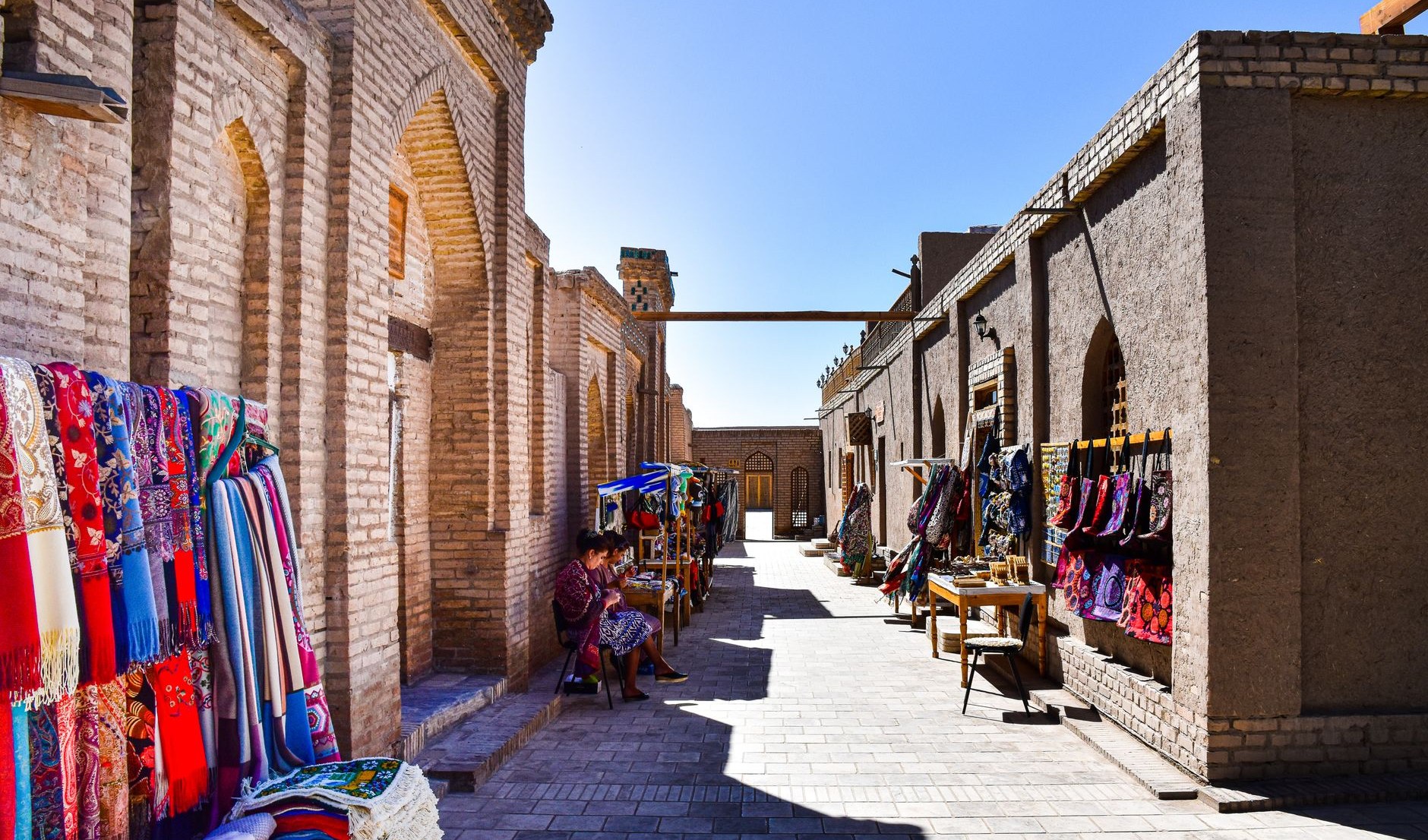 Carpets and crafts under the arches of a covered trading bazaar in Bukhara