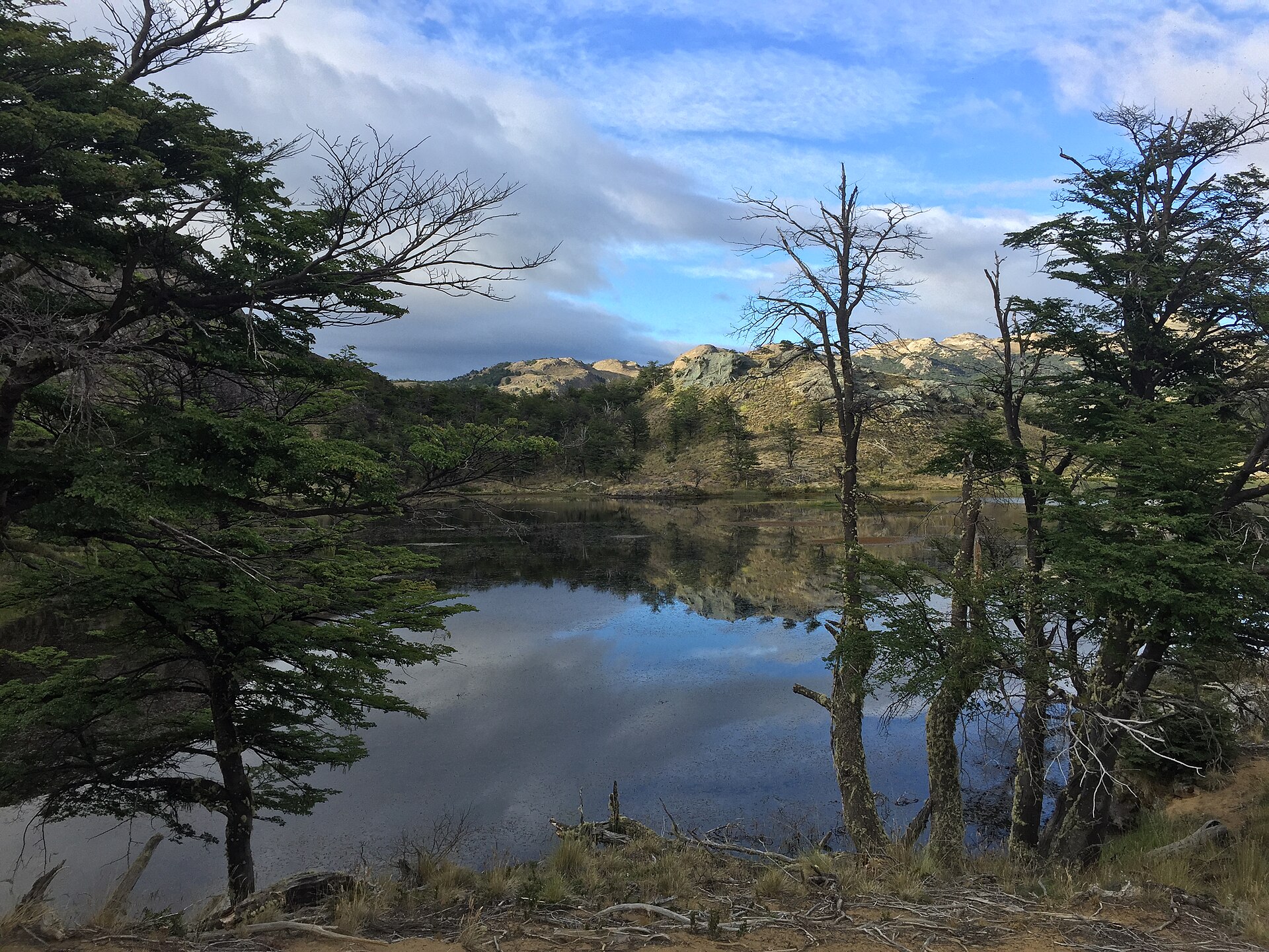 A still high lagoon under snow-streaked peaks on the Lagunas Altas trail