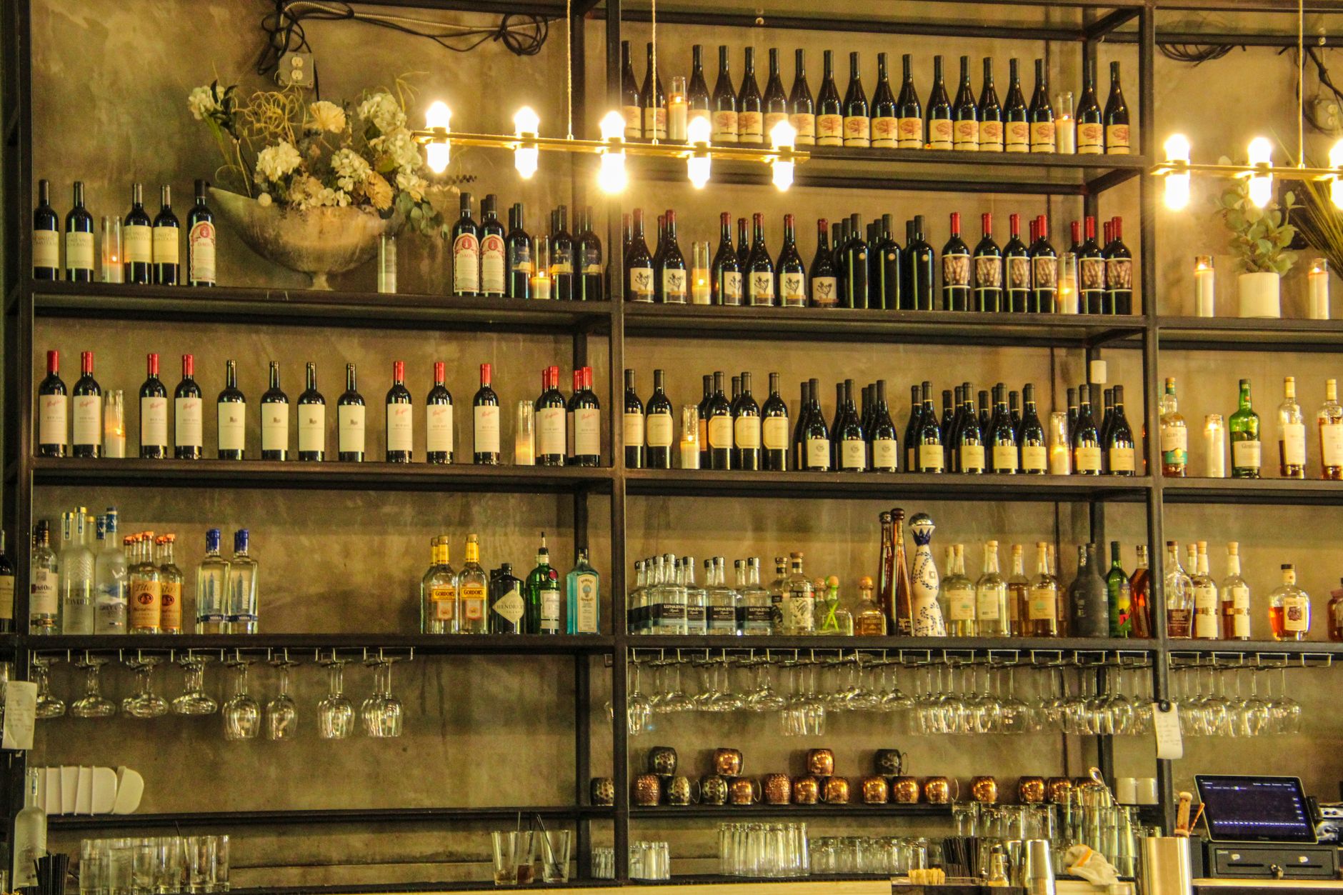 The bottle-lined interior of a Venetian bacaro wine bar, cicchetti and glasses on the counter
