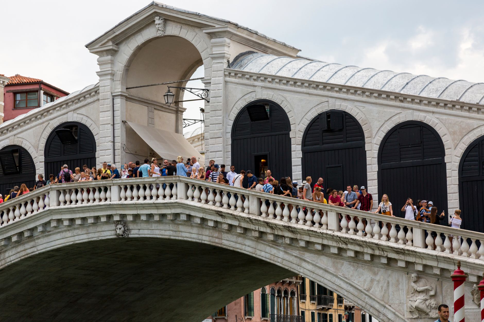 The Rialto Bridge over the Grand Canal in Venice, boats passing beneath
