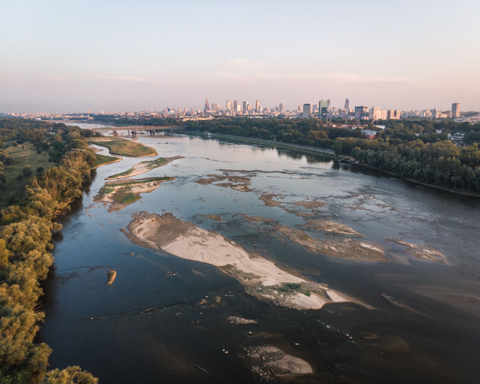 Aerial view of the Vistula's sandbanks curving through Warsaw at sunset