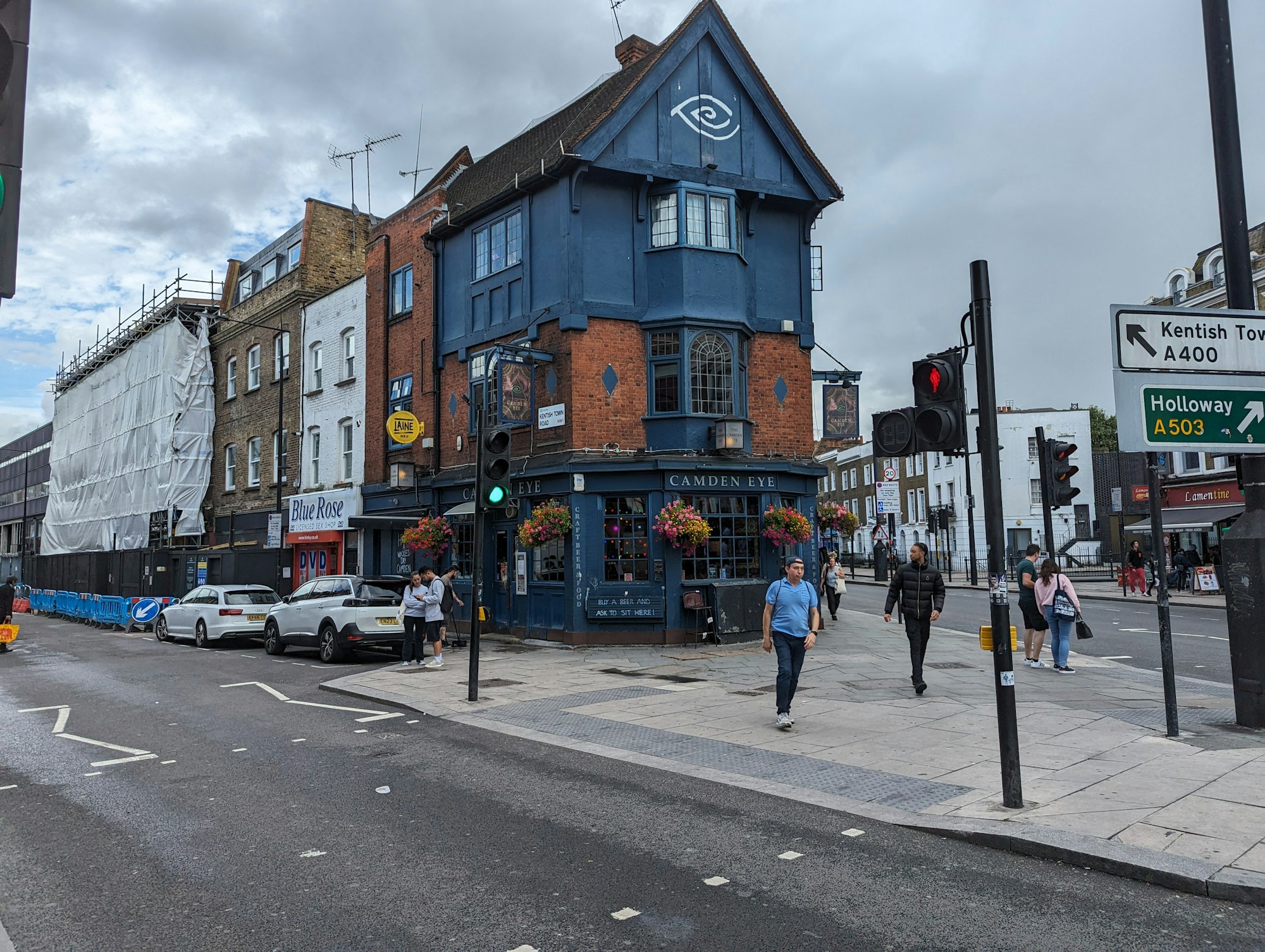 A pub and shopfronts on a street in Wimbledon Village